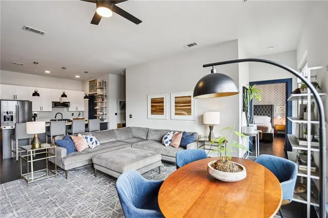 a living room with furniture and a wooden floor