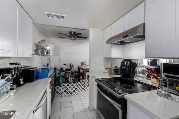 a bedroom with bed and a chandelier