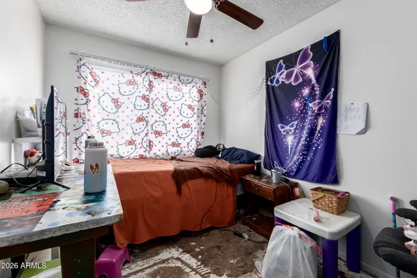 a bedroom with a bed and a flat screen tv