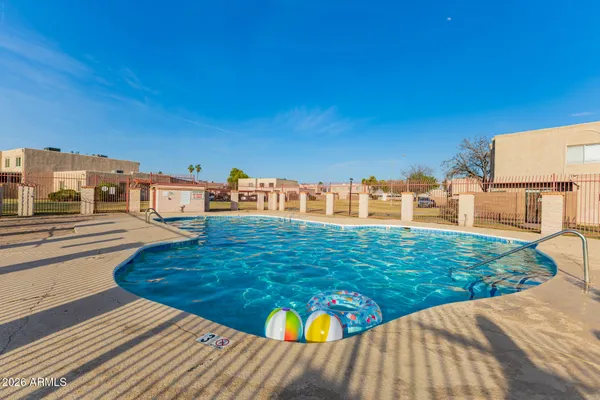 a blue swimming pool with yard