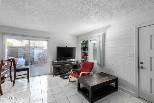 a livingroom with furniture and gym equipment