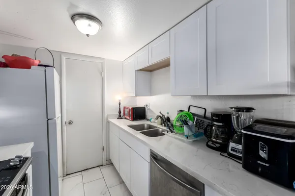 a kitchen with stainless steel appliances granite countertop a sink and cabinets