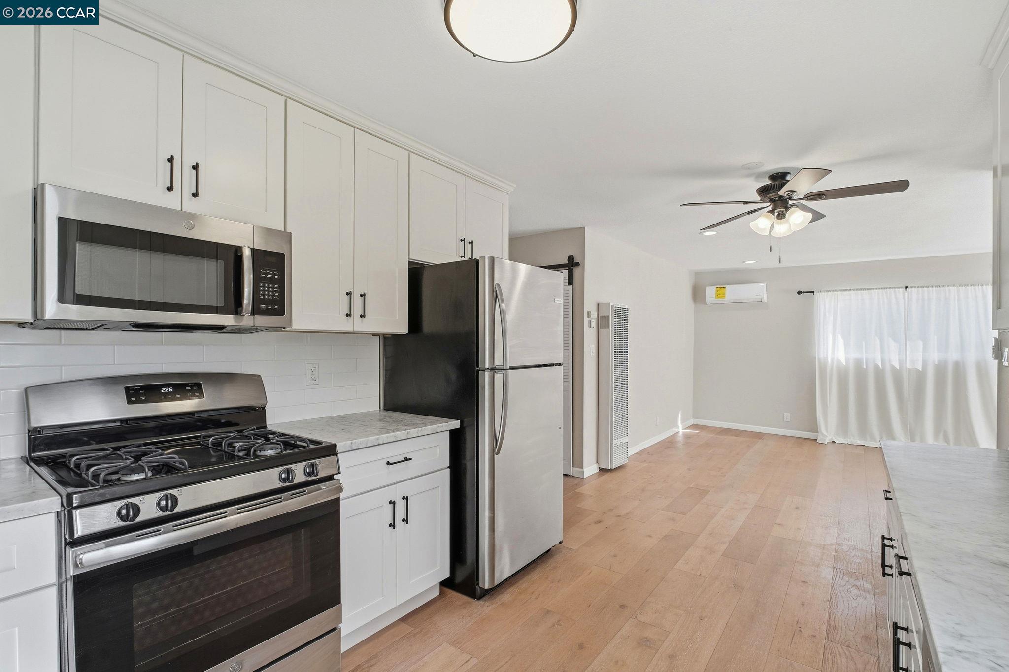 22824 High Street Hayward, CA 94541 - Photo 11 of 28 a kitchen with a stove a refrigerator and a microwave