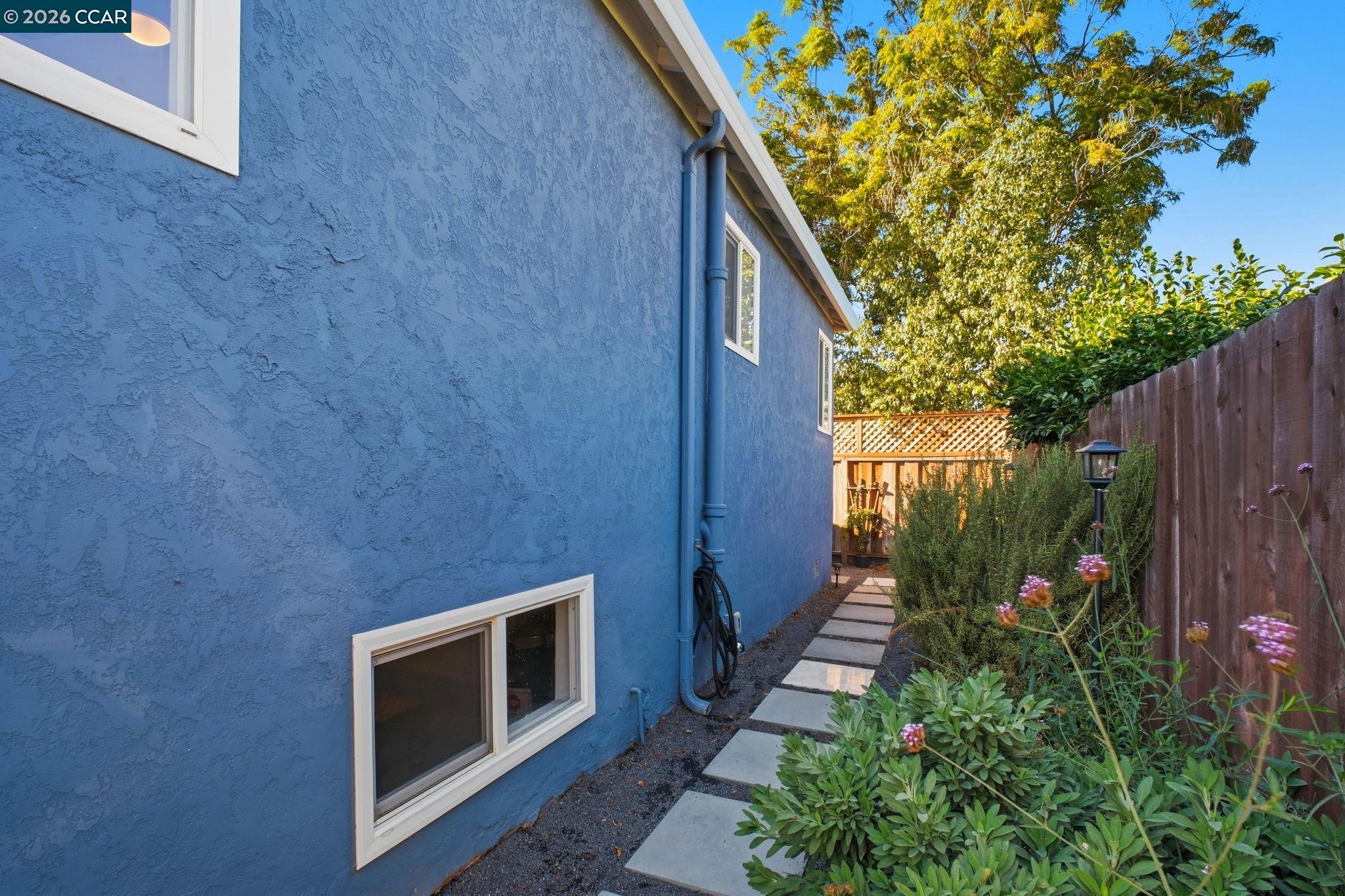 22824 High Street Hayward, CA 94541 - Photo 26 of 28 a view of a backyard with potted plants and wooden fence