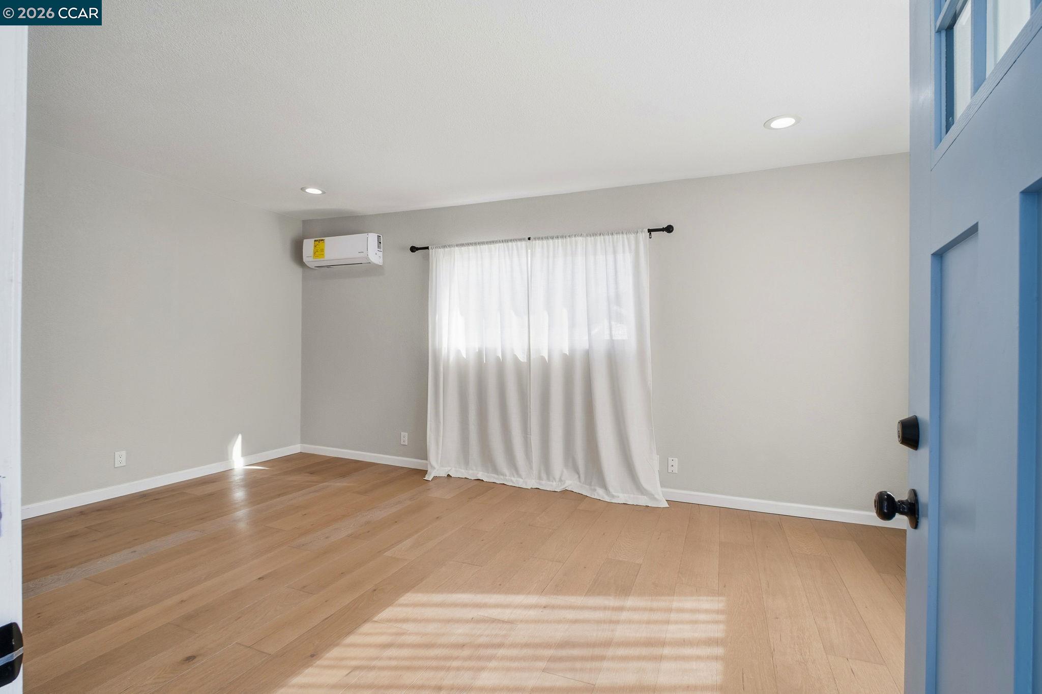 22824 High Street Hayward, CA 94541 - Photo 7 of 28 a view of an empty room with wooden floor and a window