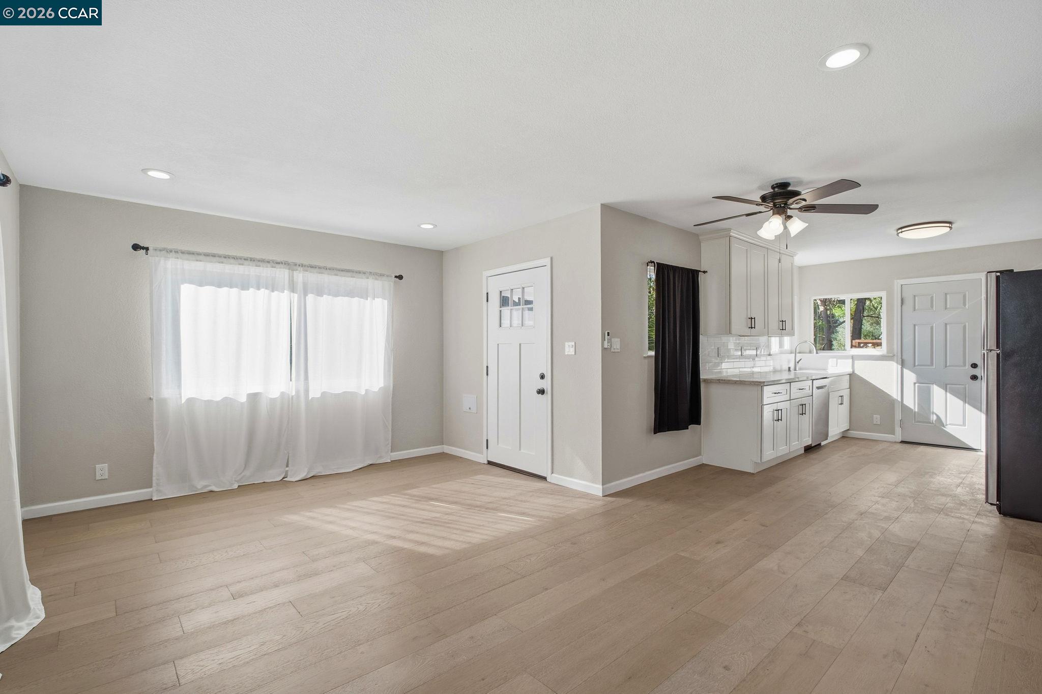 22824 High Street Hayward, CA 94541 - Photo 8 of 28 a view of a big room with windows and a ceiling fan