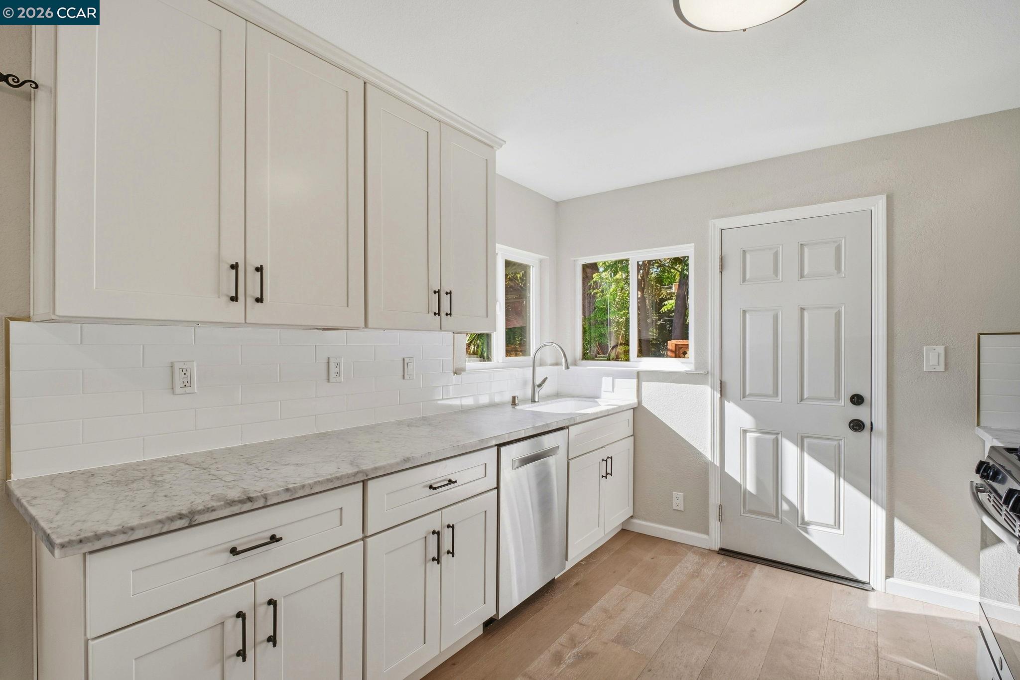 22824 High Street Hayward, CA 94541 - Photo 10 of 28 a kitchen with granite countertop white cabinets and a sink