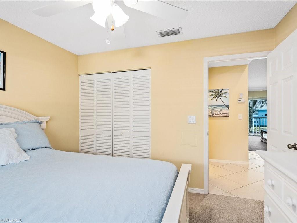 149 Wading Bird Circle, Unit I205 Naples, FL 34110 - Photo 14 of 27 a bedroom with a bed and a shower