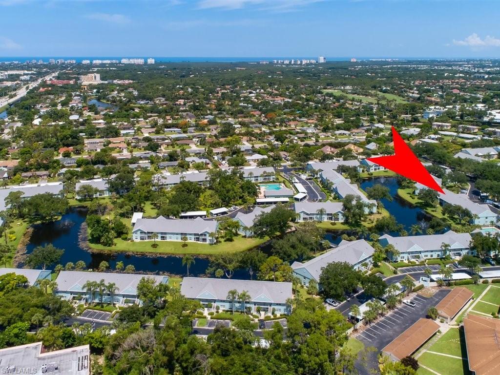149 Wading Bird Circle, Unit I205 Naples, FL 34110 - Photo 16 of 27 an aerial view of residential houses with outdoor space