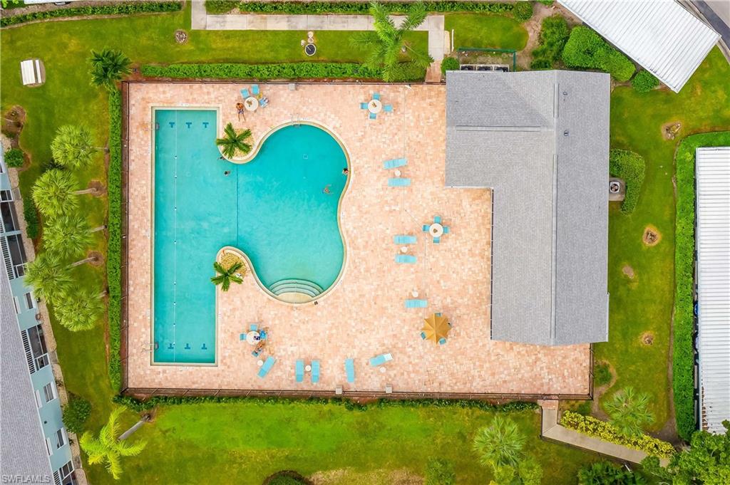 149 Wading Bird Circle, Unit I205 Naples, FL 34110 - Photo 18 of 27 an aerial view of a house with a garden and trees