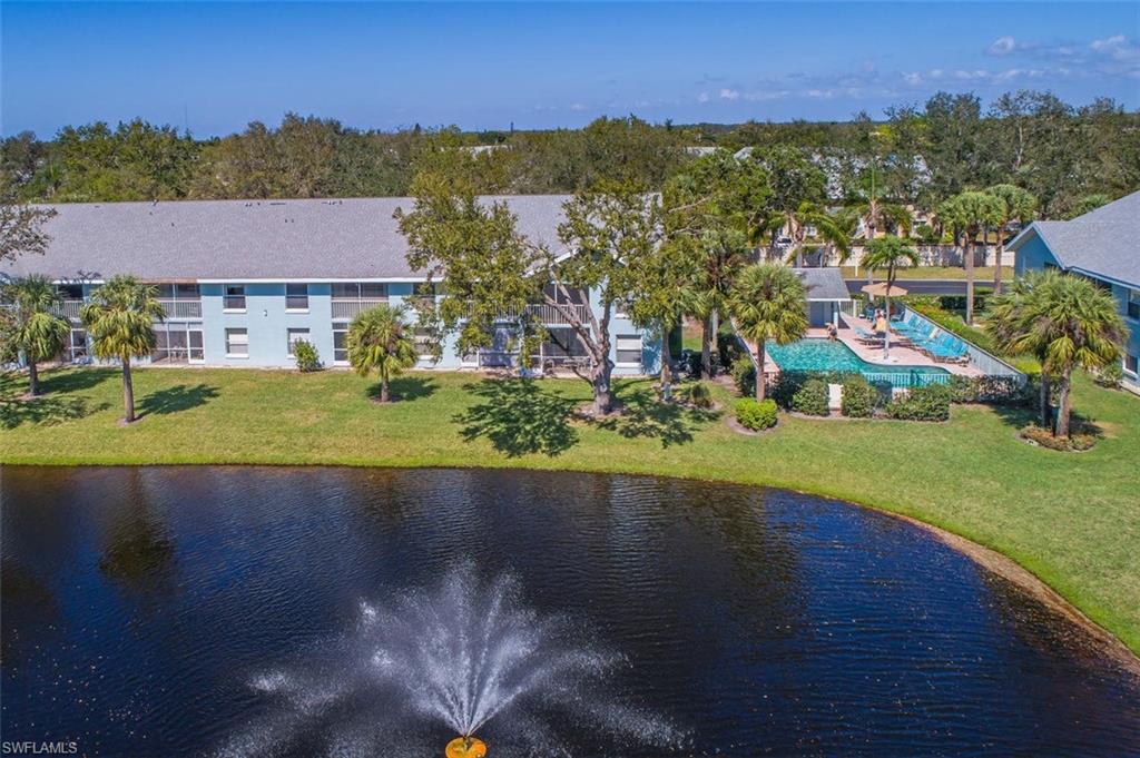 149 Wading Bird Circle, Unit I205 Naples, FL 34110 - Photo 19 of 27 an aerial view of residential houses with outdoor space and trees