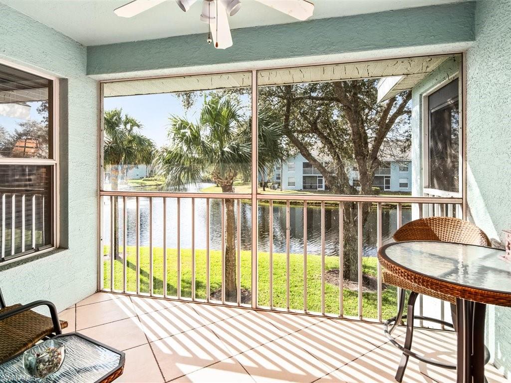 149 Wading Bird Circle, Unit I205 Naples, FL 34110 - Photo 2 of 27 a front view of a house with a swimming pool