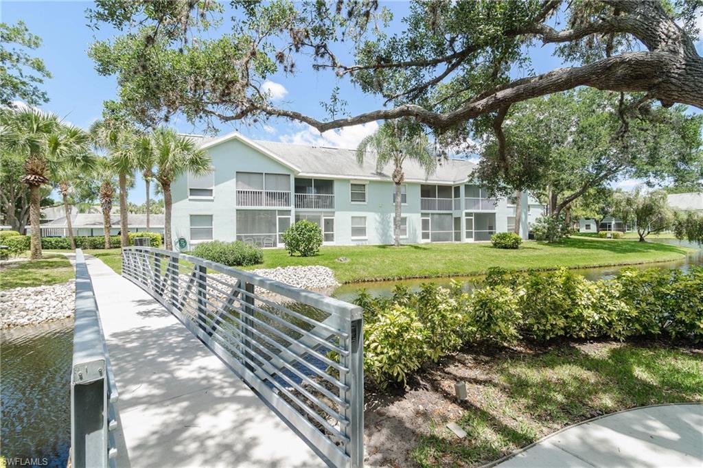 149 Wading Bird Circle, Unit I205 Naples, FL 34110 - Photo 23 of 27 a front view of a house with garden