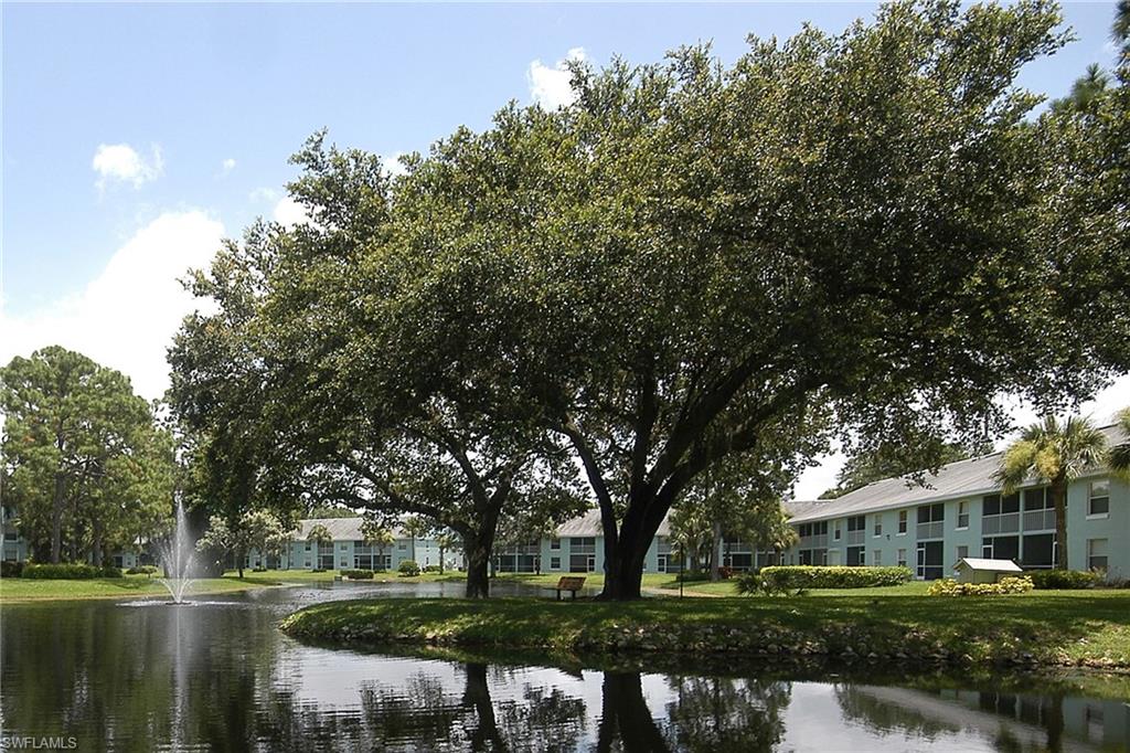 149 Wading Bird Circle, Unit I205 Naples, FL 34110 - Photo 26 of 27 a front view of a house with a yard