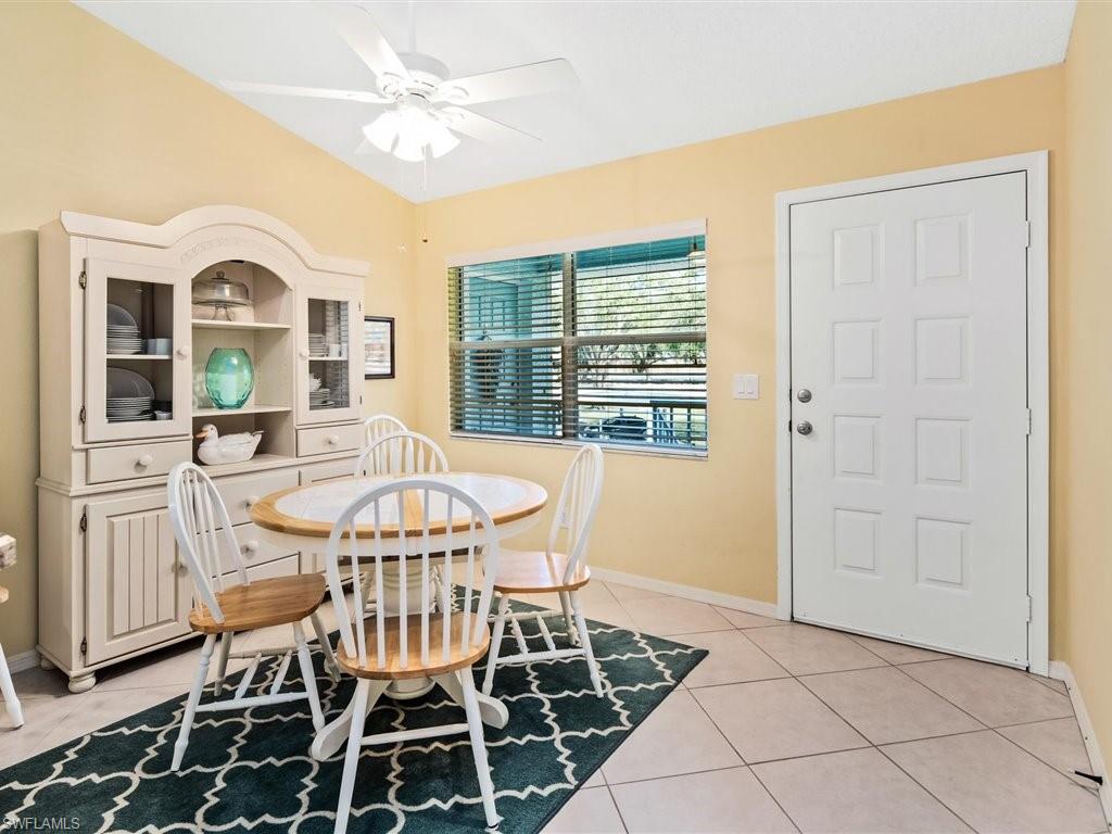 149 Wading Bird Circle, Unit I205 Naples, FL 34110 - Photo 9 of 27 a view of a dining room with furniture window and outside view