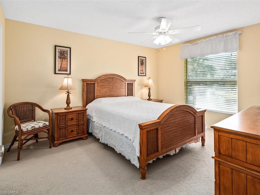 149 Wading Bird Circle, Unit I205 Naples, FL 34110 - Photo 10 of 27 a bedroom with a bed and a furniture