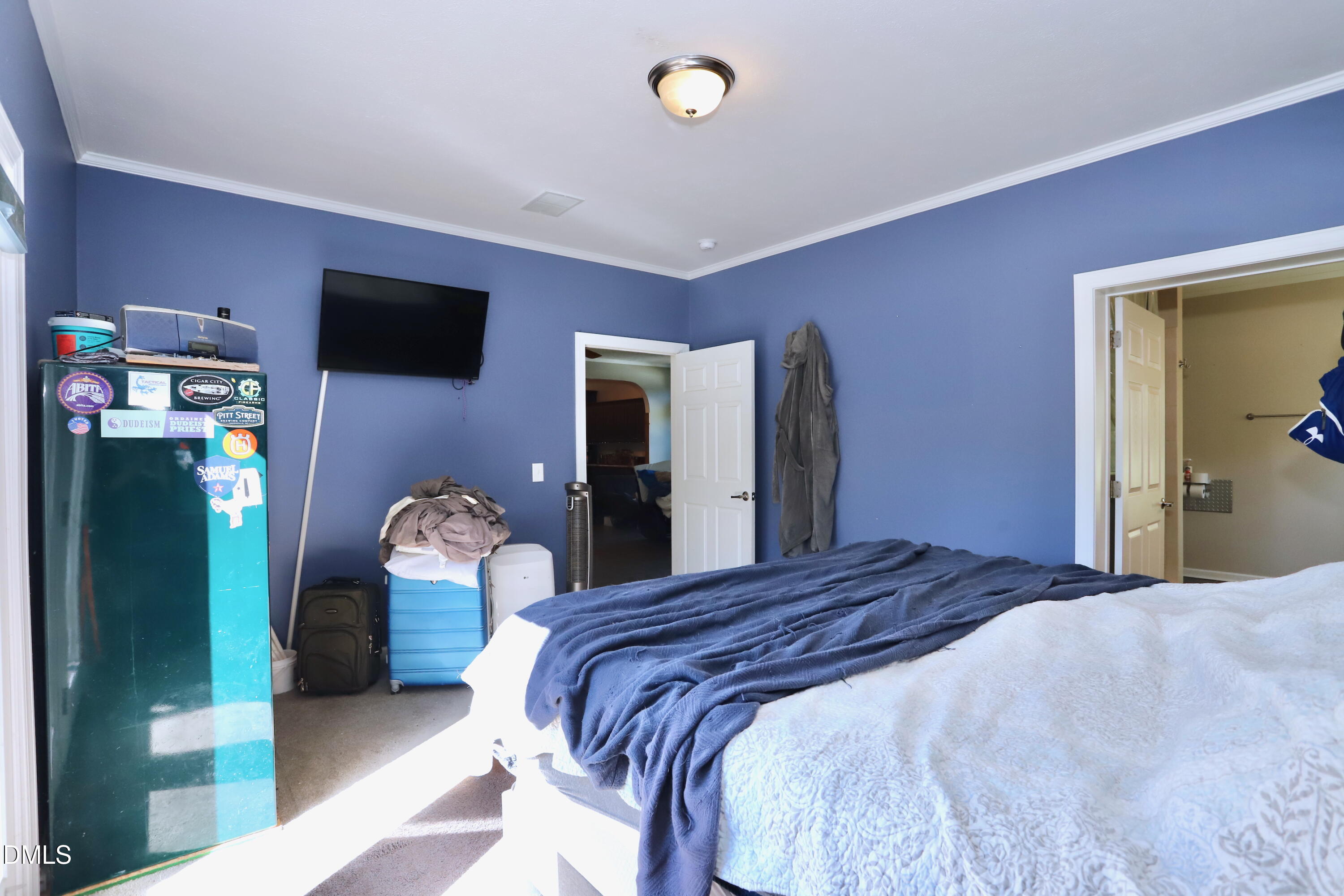 6764 Bradshaw Farm Road Efland, NC 27243 - Photo 14 of 56 a bedroom with a bed and a tv