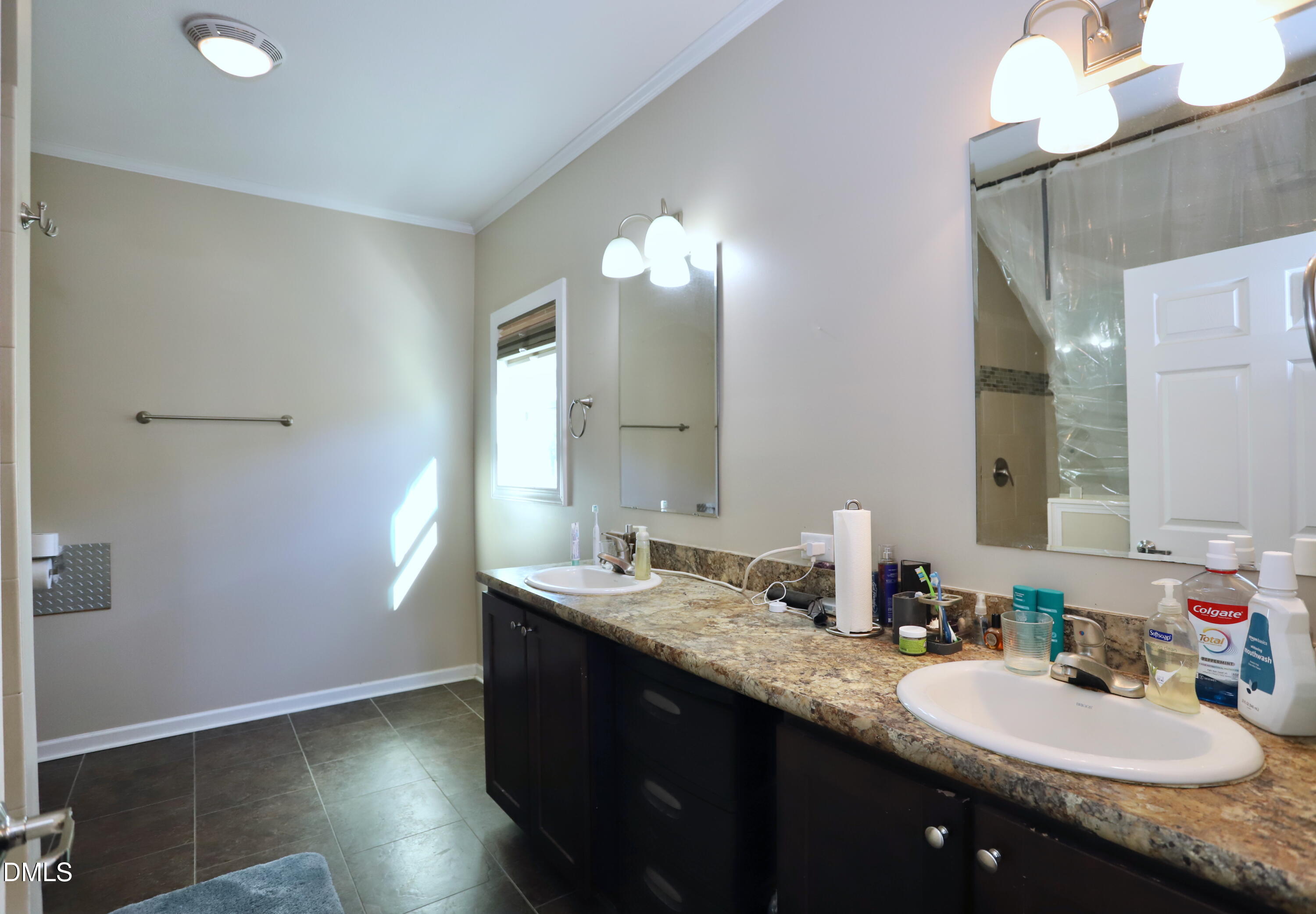6764 Bradshaw Farm Road Efland, NC 27243 - Photo 15 of 56 a bathroom with a sink double vanity and a mirror