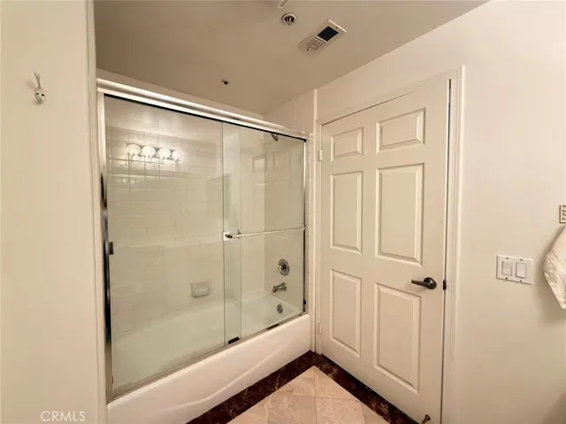 a bathroom with a glass shower door