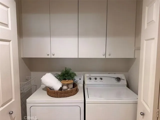 a utility room with closet dryer and washer