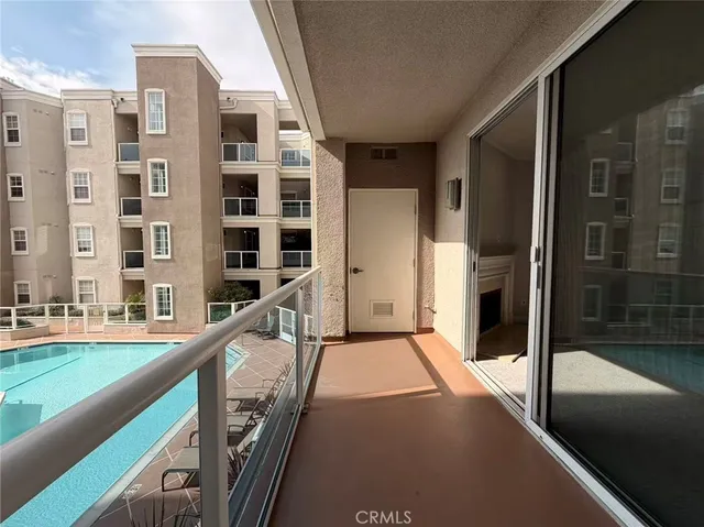 a view of an buildings with a swimming pool and outdoor seating
