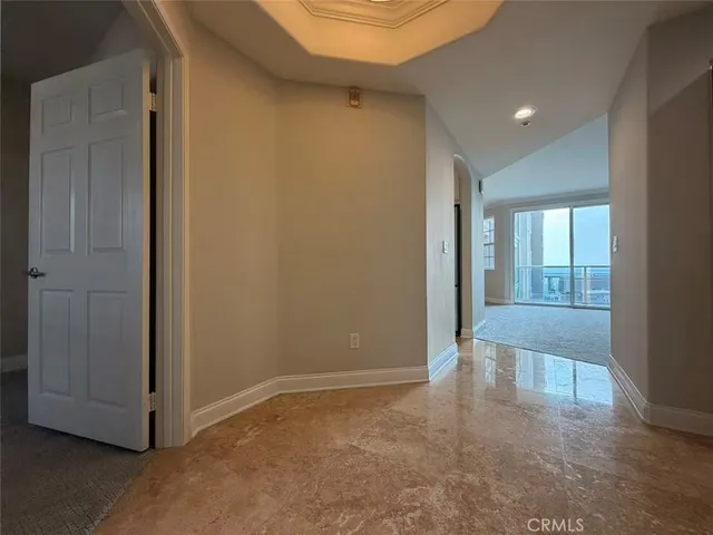 an empty room with large windows and closet