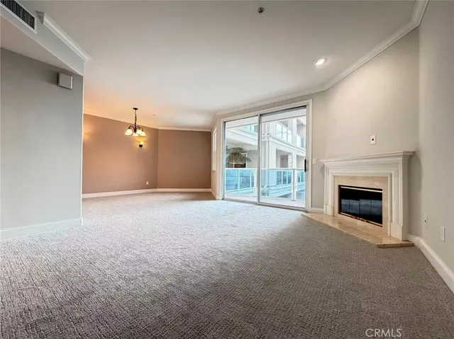 a view of empty room with a fireplace
