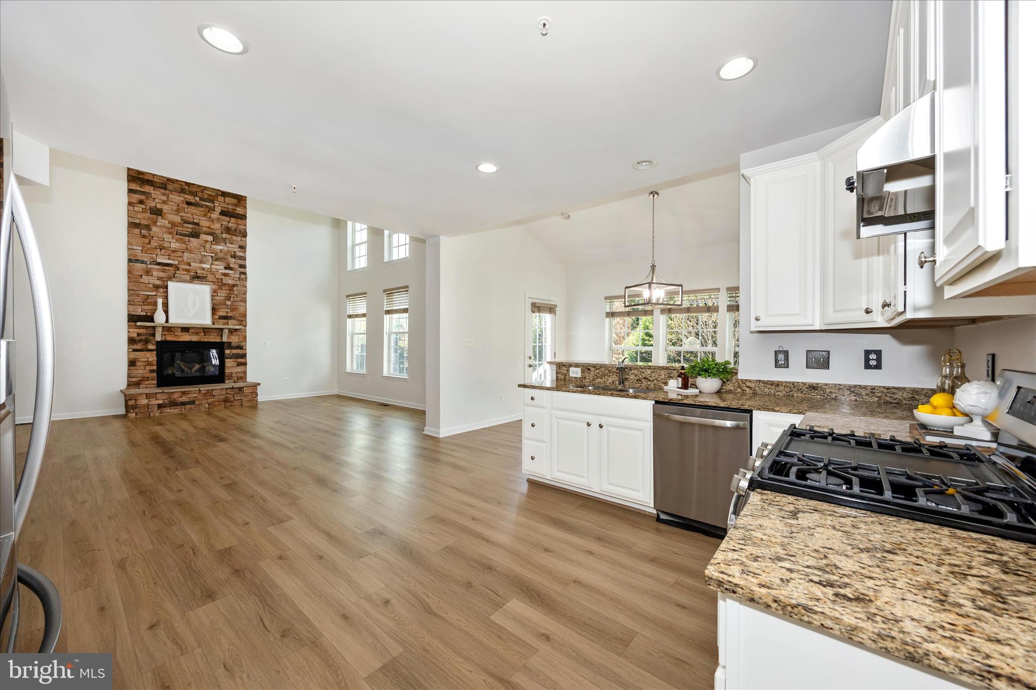 9145 Bealls Farm Road Frederick, MD 21704 - Photo 14 of 88 a kitchen with stainless steel appliances granite countertop a stove a sink dishwasher and a refrigerator with wooden floor