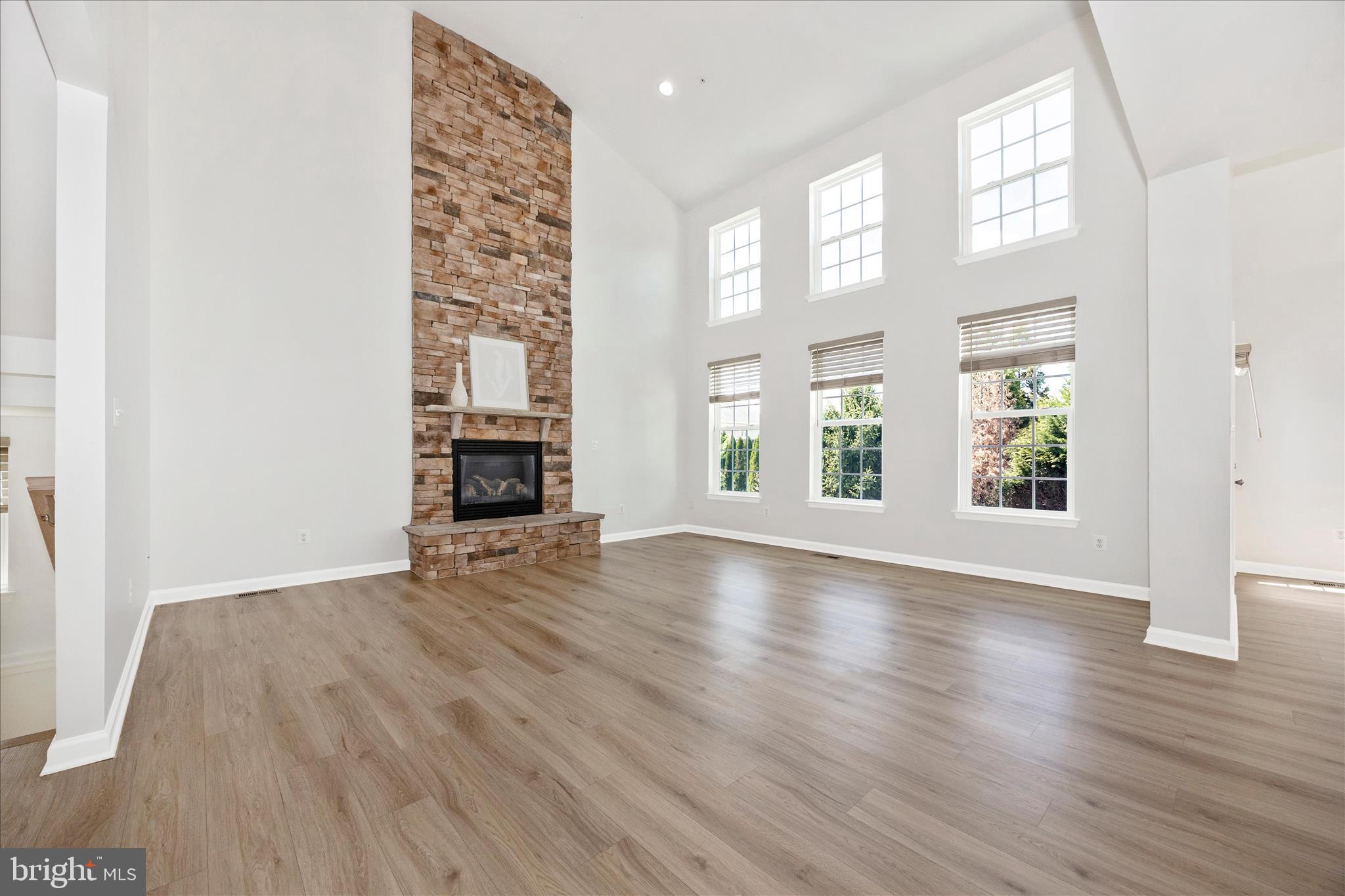 9145 Bealls Farm Road Frederick, MD 21704 - Photo 16 of 88 an empty room with wooden floor fireplace and windows
