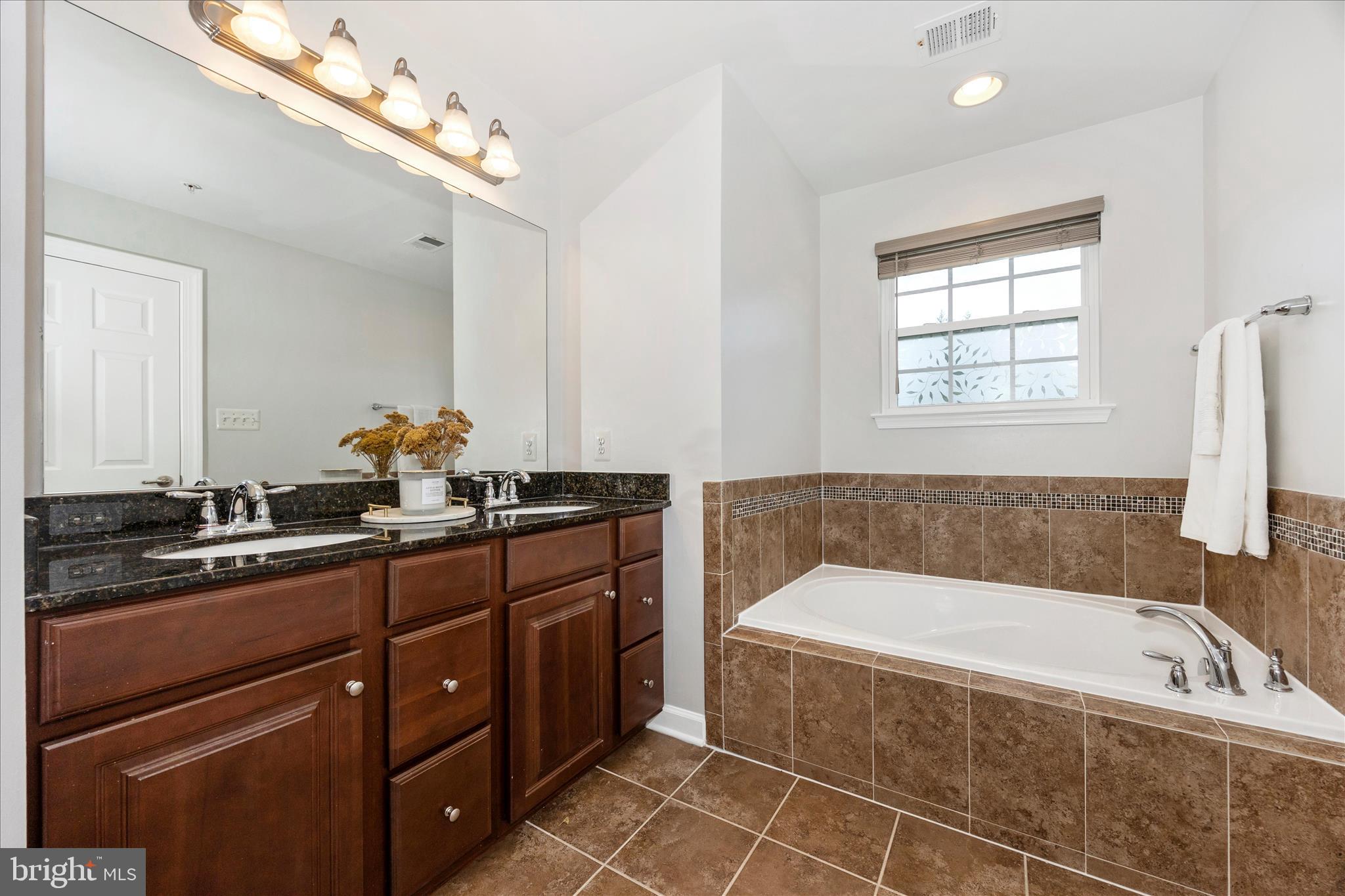 9145 Bealls Farm Road Frederick, MD 21704 - Photo 27 of 88 a bathroom with a tub a sink and mirror