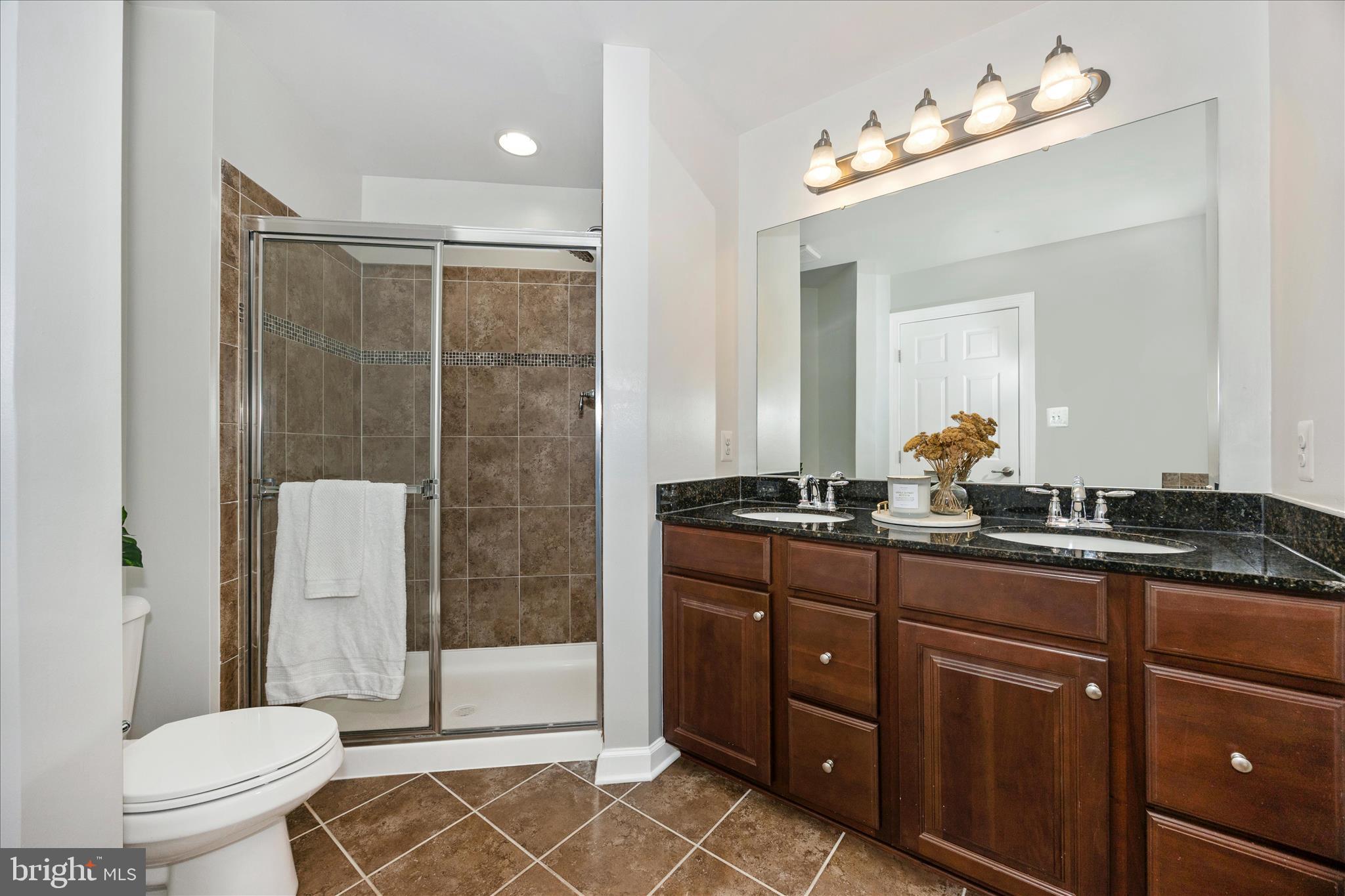 9145 Bealls Farm Road Frederick, MD 21704 - Photo 28 of 88 a bathroom with a double vanity sink toilet mirror and shower