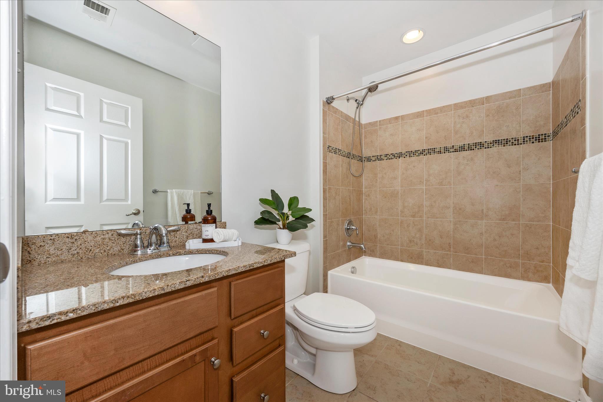 9145 Bealls Farm Road Frederick, MD 21704 - Photo 32 of 88 a bathroom with a granite countertop sink toilet and shower