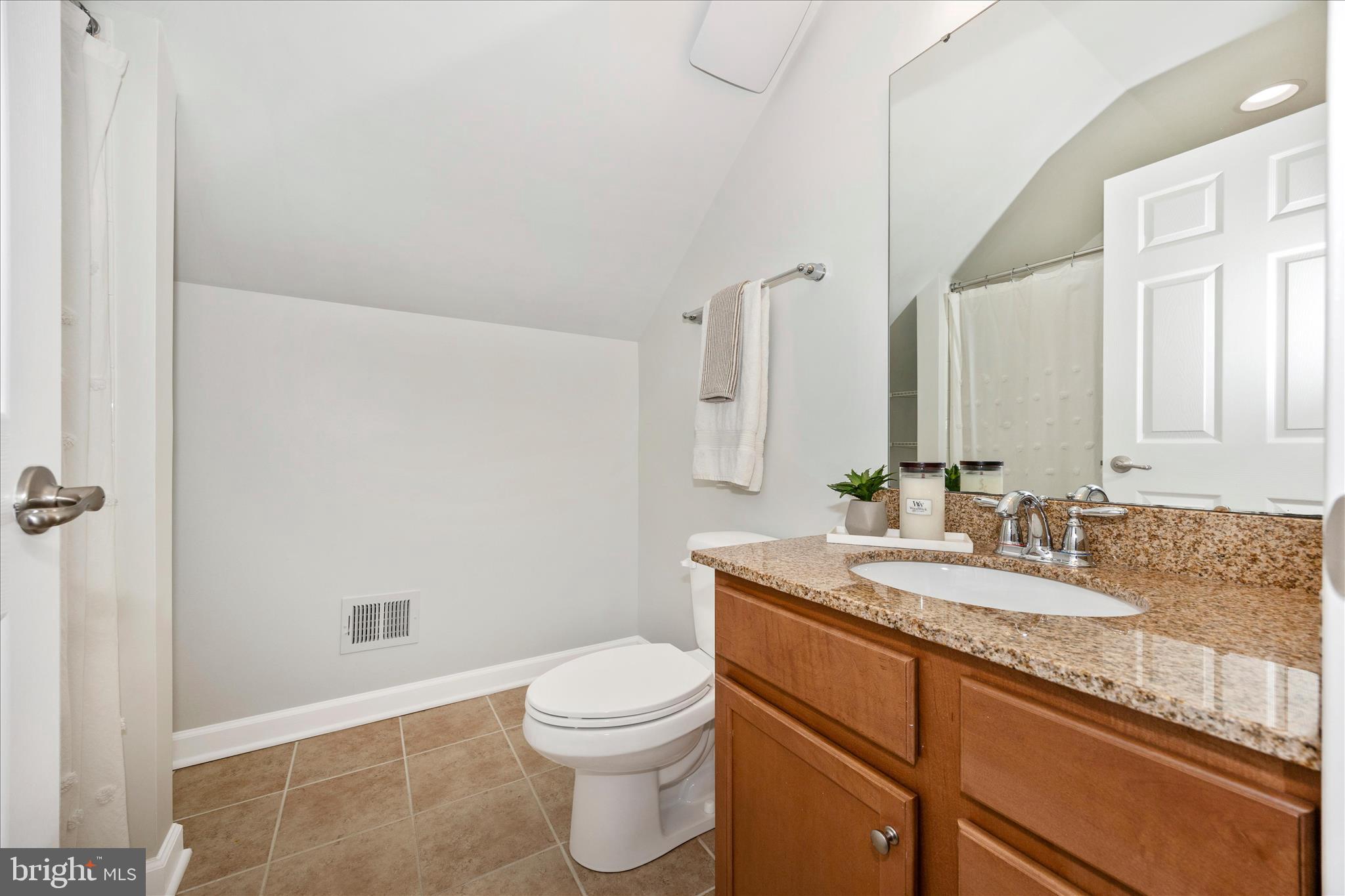 9145 Bealls Farm Road Frederick, MD 21704 - Photo 38 of 88 a bathroom with a granite countertop sink a toilet and a mirror