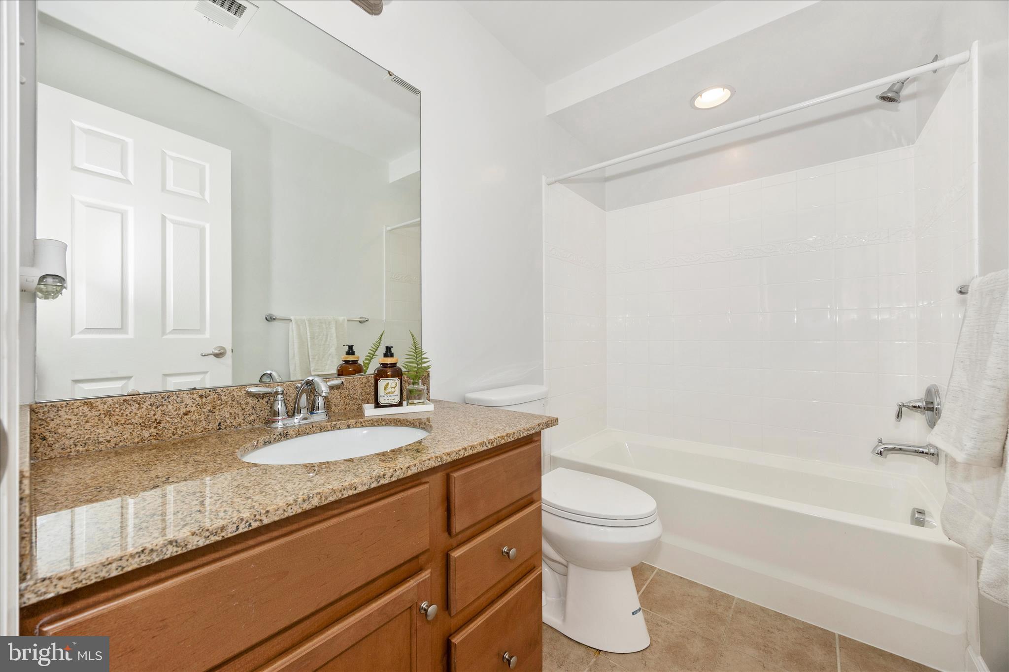 9145 Bealls Farm Road Frederick, MD 21704 - Photo 44 of 88 a bathroom with a granite countertop sink a toilet and bathtub
