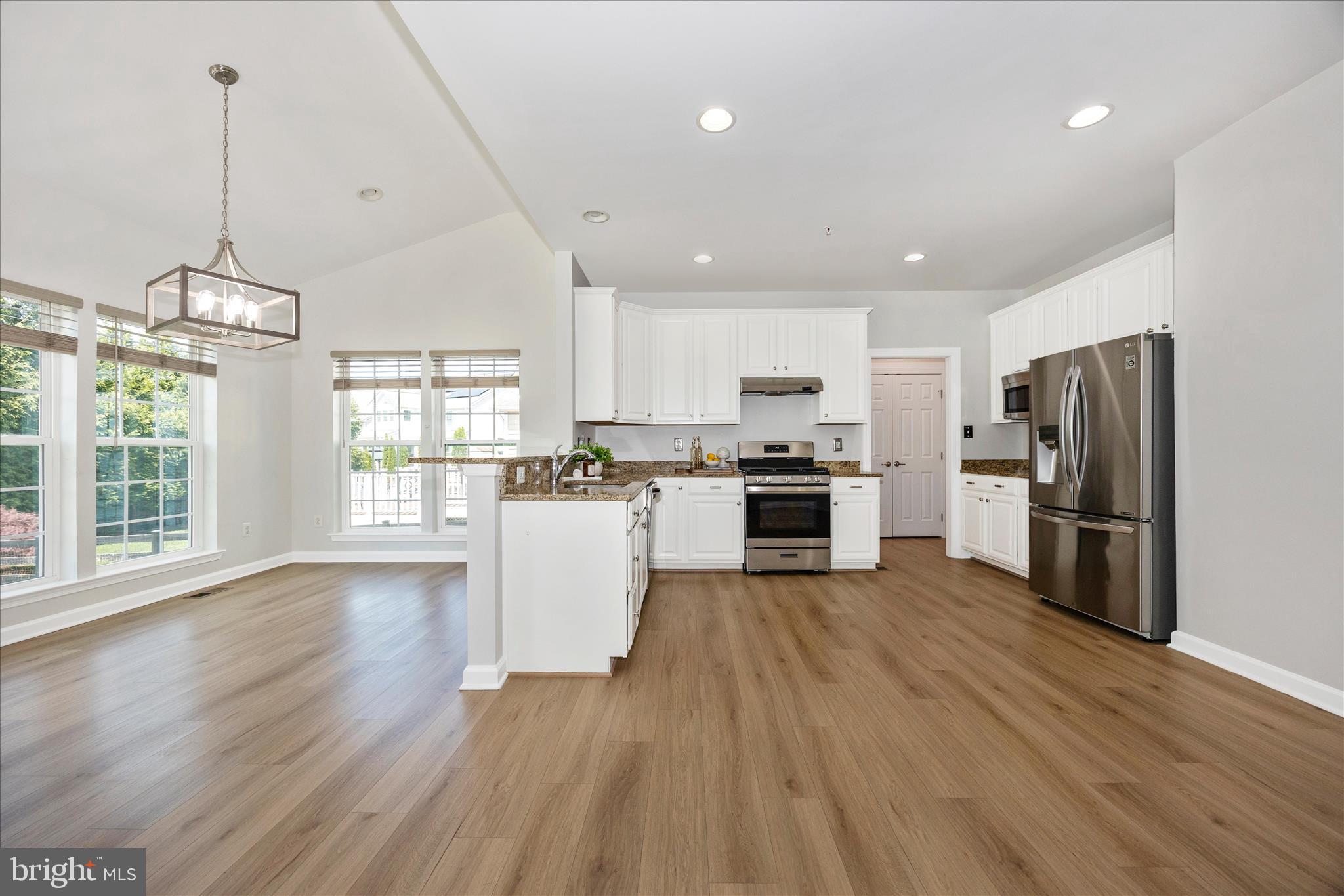 9145 Bealls Farm Road Frederick, MD 21704 - Photo 8 of 88 a view of kitchen with refrigerator microwave and wooden floor