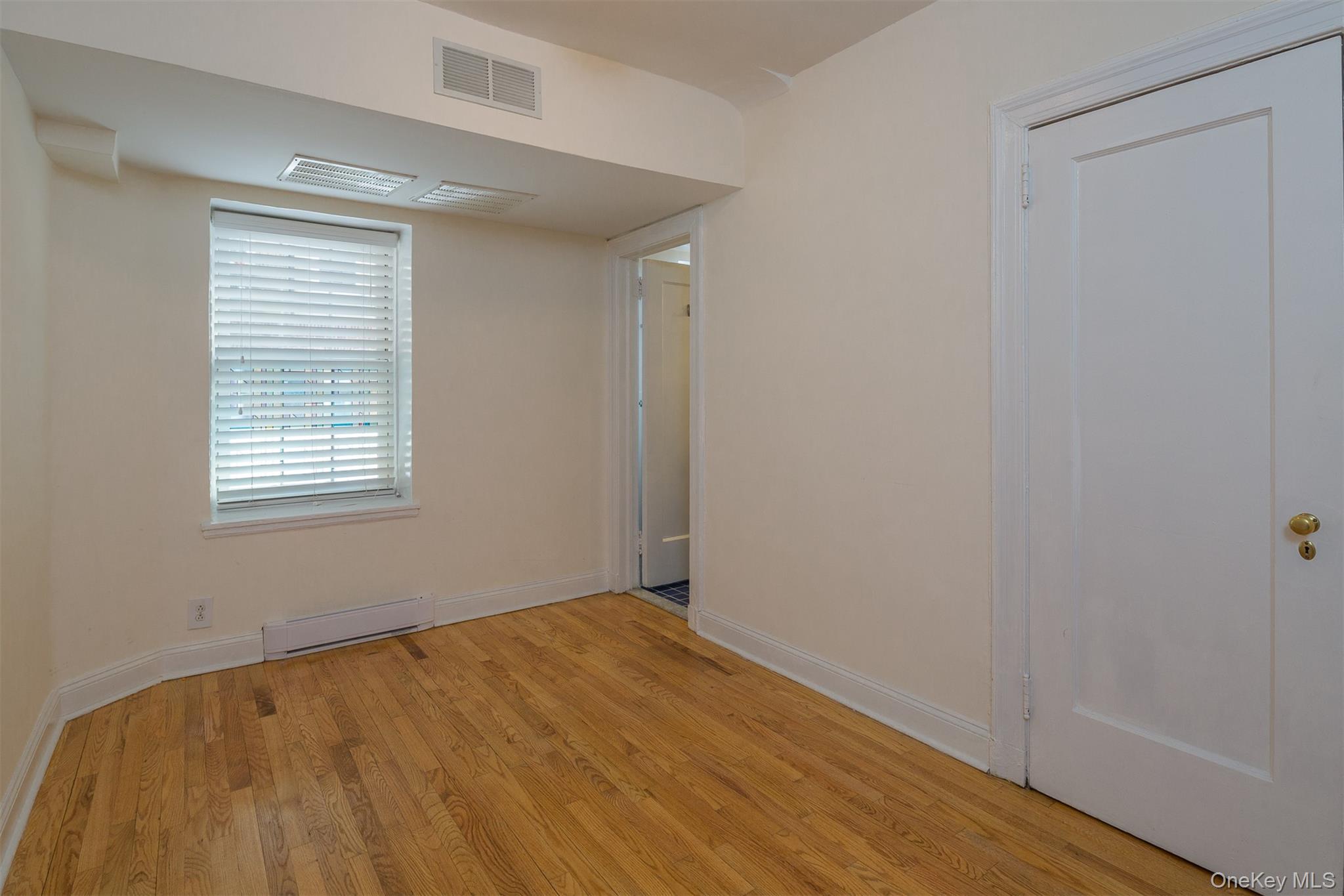 9 Alden Place, Unit G9 Bronxville, NY 10708 - Photo 7 of 11 wooden floor in an empty room with a window