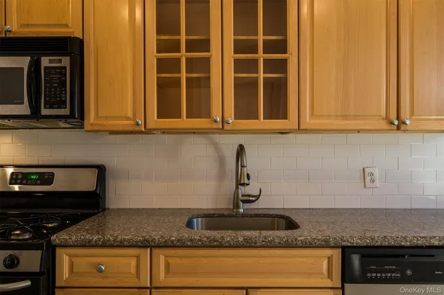 a kitchen with granite countertop cabinets and stainless steel appliances