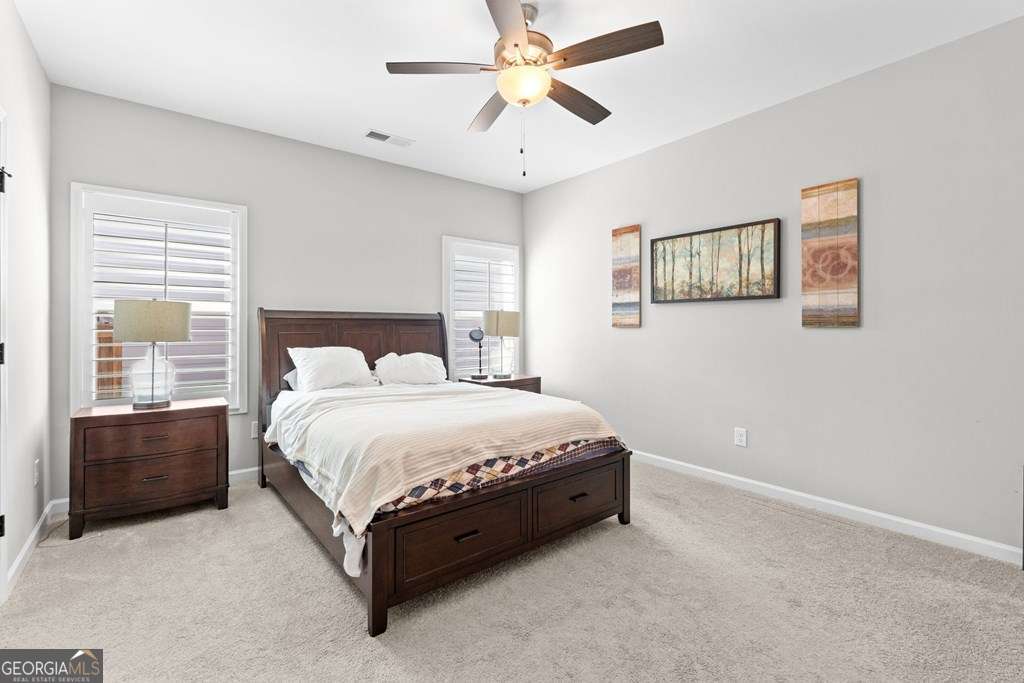 121 Cedar Pk Way Carrollton, GA 30117 - Photo 15 of 33 a spacious bedroom with a bed and a chandelier