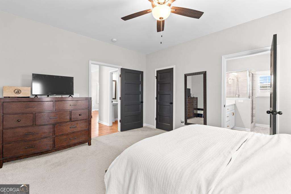 121 Cedar Pk Way Carrollton, GA 30117 - Photo 16 of 33 a bedroom with a bed and a flat screen tv