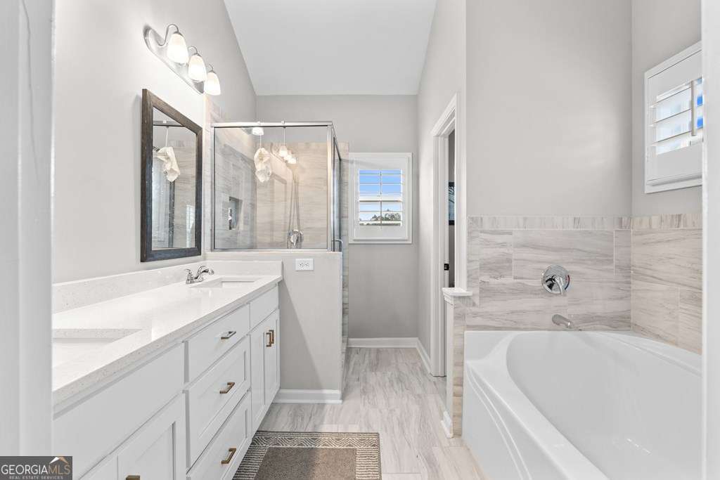 121 Cedar Pk Way Carrollton, GA 30117 - Photo 17 of 33 a bathroom with a tub sink and mirror
