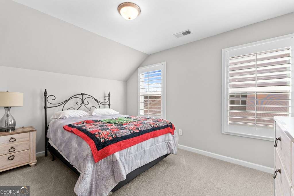 121 Cedar Pk Way Carrollton, GA 30117 - Photo 23 of 33 a bedroom with a bed and a window