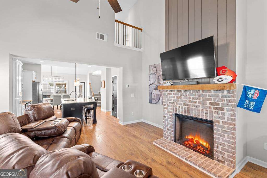 121 Cedar Pk Way Carrollton, GA 30117 - Photo 5 of 33 a living room with furniture a flat screen tv and a fireplace