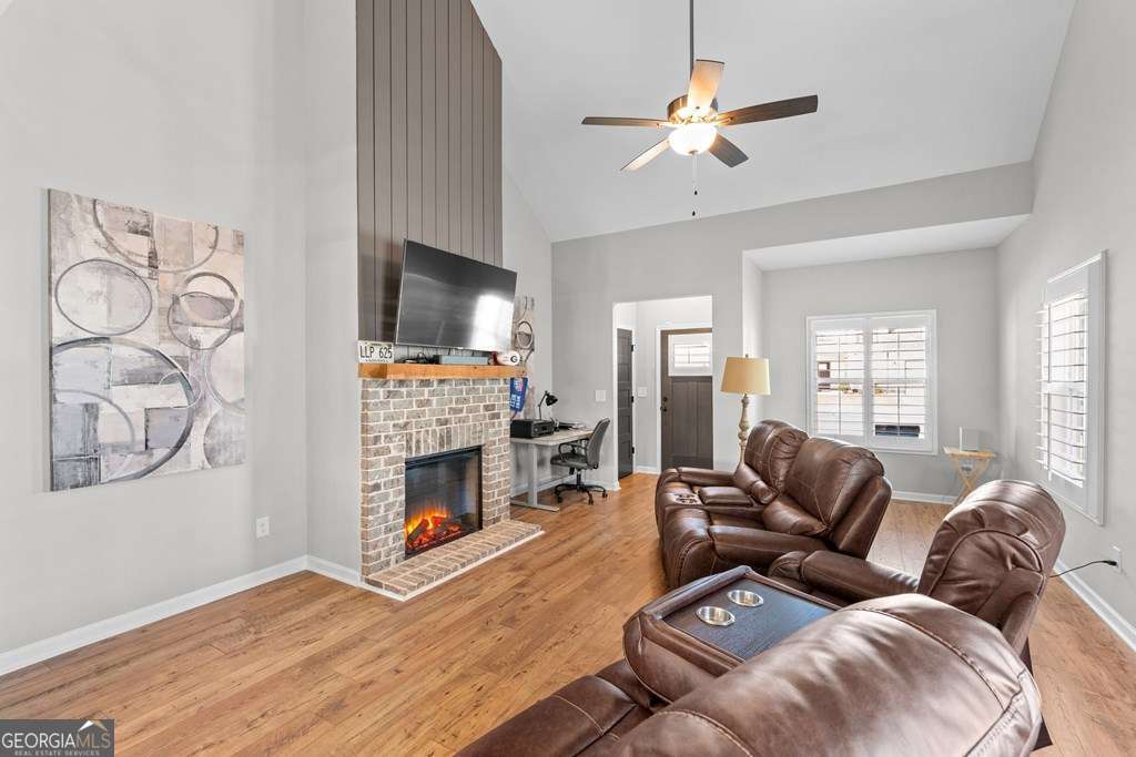 121 Cedar Pk Way Carrollton, GA 30117 - Photo 7 of 33 a living room with furniture flat screen tv and a fireplace