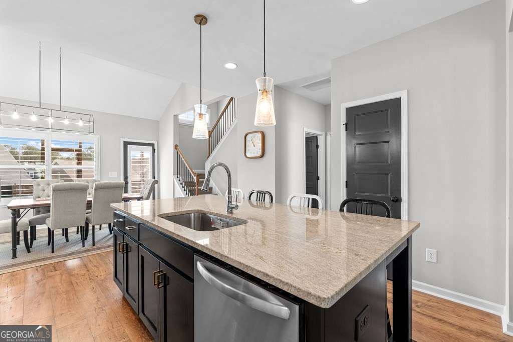 121 Cedar Pk Way Carrollton, GA 30117 - Photo 10 of 33 a kitchen with kitchen island a sink and wooden floor