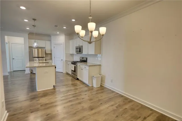 a view of a kitchen with a sink stainless steel appliances and cabinets