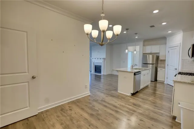 a kitchen with stainless steel appliances a refrigerator and a stove top oven