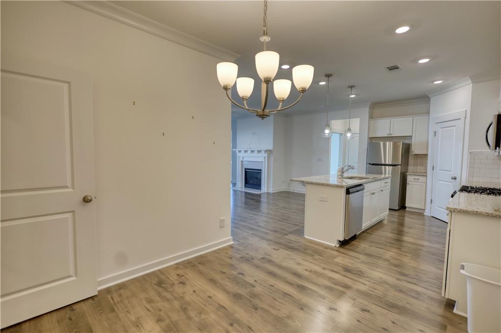 2929 Rambler Drive Loganville, GA 30052 - Photo 23 of 49 a view of a kitchen with a sink stainless steel appliances and cabinets