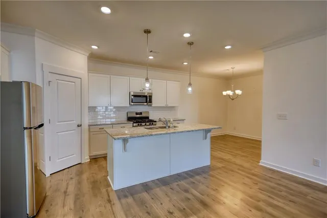 a view of a kitchen with microwave and cabinets