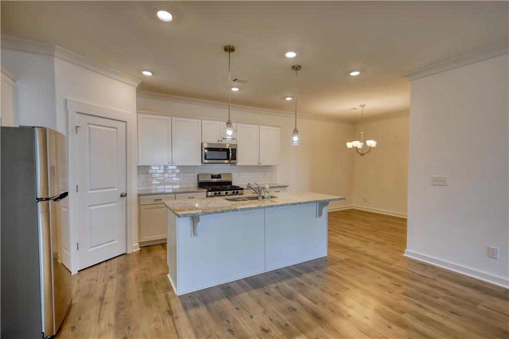 2929 Rambler Drive Loganville, GA 30052 - Photo 24 of 49 a kitchen with stainless steel appliances a refrigerator and a stove top oven