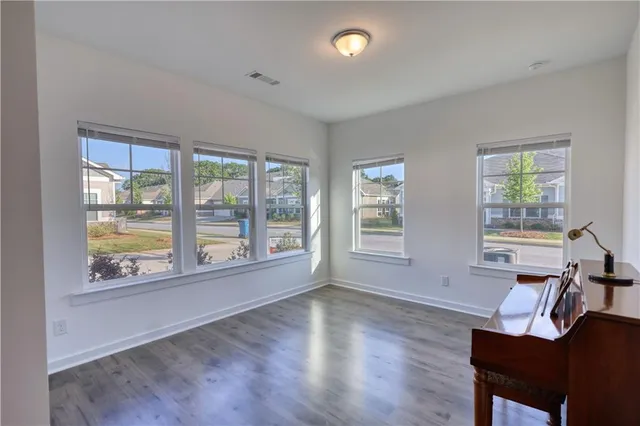a room with a piano and wooden floor
